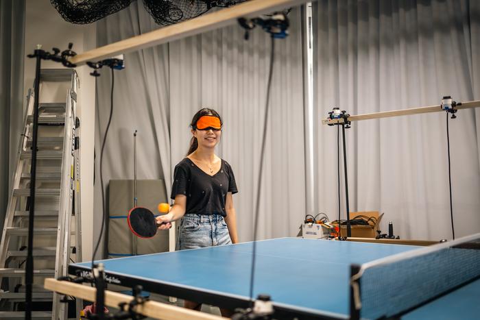 Motion tracking cameras and an array of linked speakers give real-time audio feedback to table tennis players