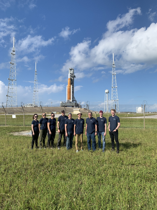 Researchers gather in front of SLS rocket prior to launch