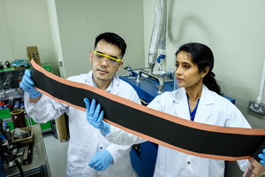 NTU Prof Madhavi with senior research engineer Mr Tanto Soh examining prototype of new lithium ion batteries