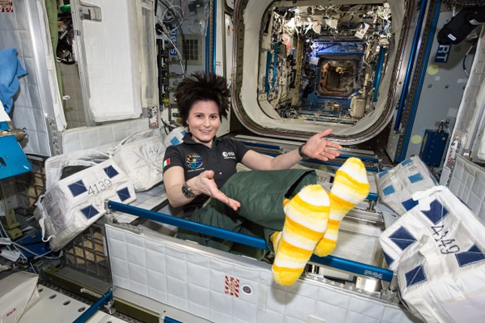 ESA (European Space Agency) astronaut Samantha Cristoforetti shows off her yellow and white striped socks aboard the space station.