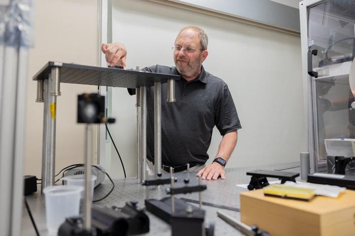 Scott Bailey with optics equipment.