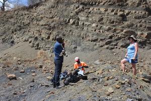 G2: On the left side (Nelson Nhamutole-PhD student), and his main supervisor Prof. Marion Bamford (on the right side) discussing some important aspects regarding the outcrop sampling in the Michunwa outcrop. On the middle (Imede Macungo), a local guide f
