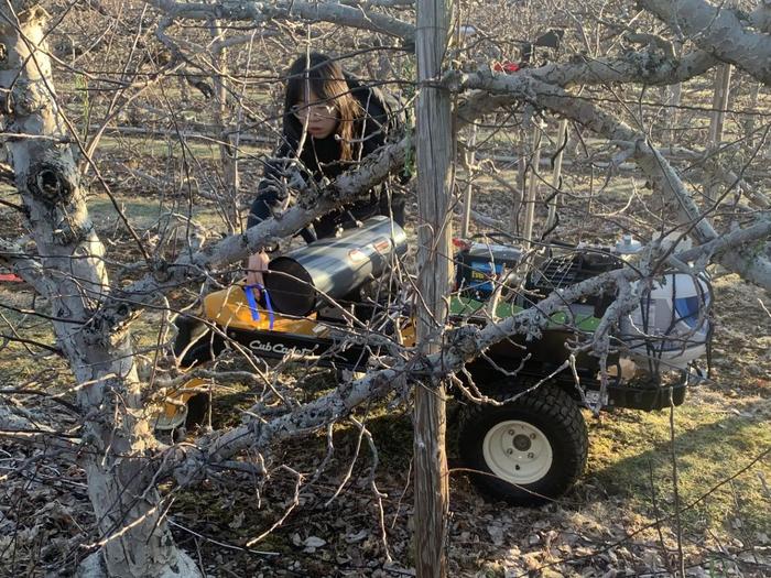 Weyuin Hua, a graduate assistant, is shown here adjusting the unmanned ground vehicle