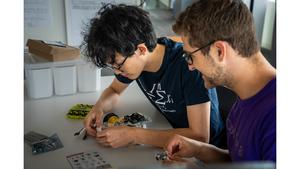 Students tinker with their vehicle.