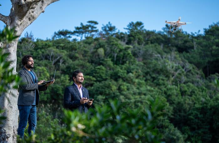 The Vyorius team flying their drone on the OIST campus