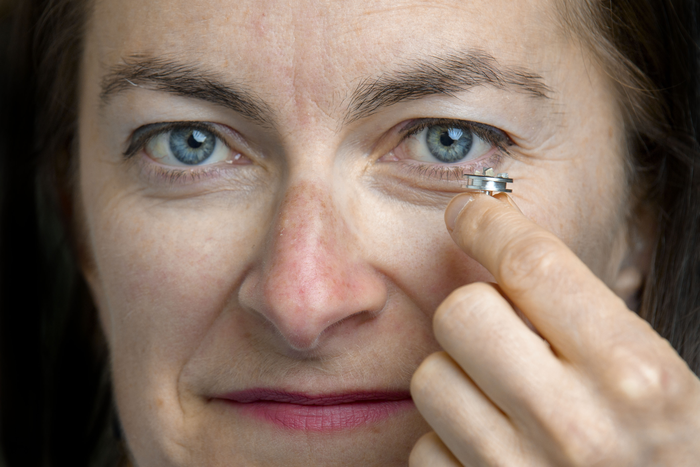 Professor Maria McNamara holding tiny samples of the pterosaur feathers
