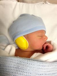 Baby with Ear Muffs Ready for MRI Scanner