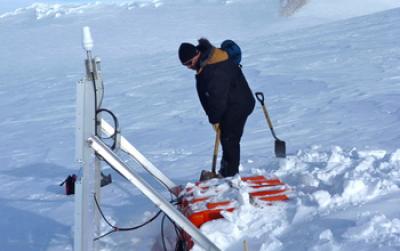 Researcher Digging out a Seismographic Instrument in Antarctica