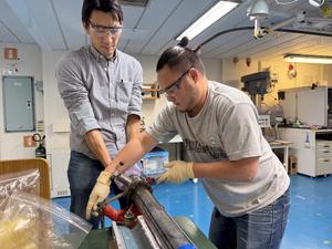 Matt Ikari (Physical Property, right), Hiroki Sone (Structure geology) are working on whole round core sampling.