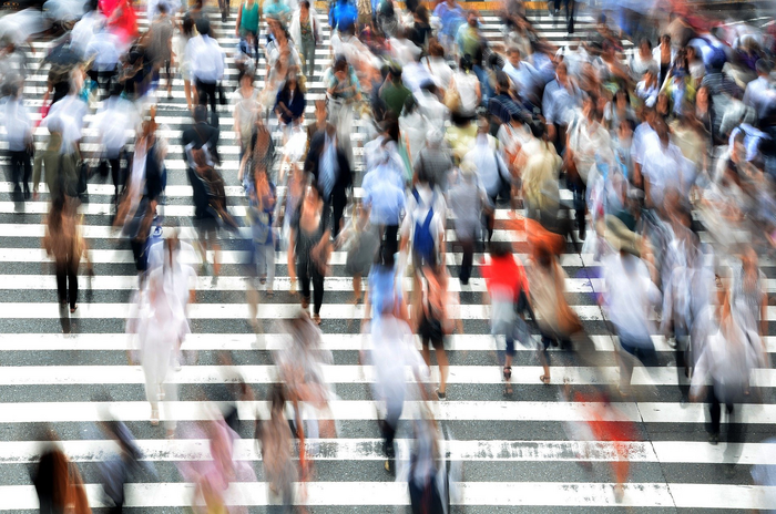 A crowd of people at a pedestrian crossing.