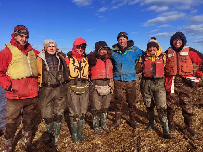 Baranes (second from right) and Woodruff (third from right) on the salt marsh with their team during spring break.