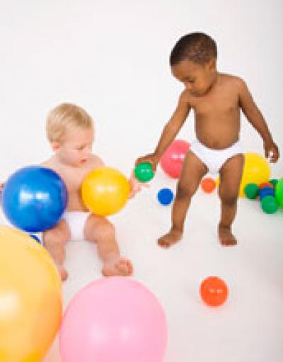 2 Young Children Playing with Balls