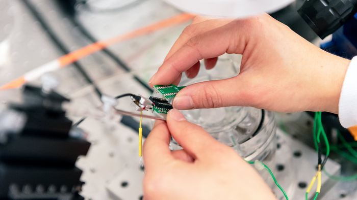 Gladstone graduate student working with an electrode array to study brain samples.