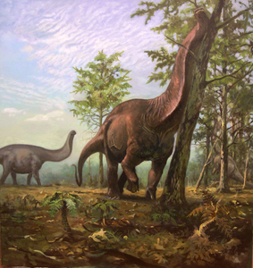 A Brontosaurus in a warm and vegetated landscape not dissimilar to modern-day savannahs