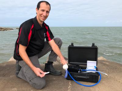 Researcher with Lateral Flow Assay Field Kit