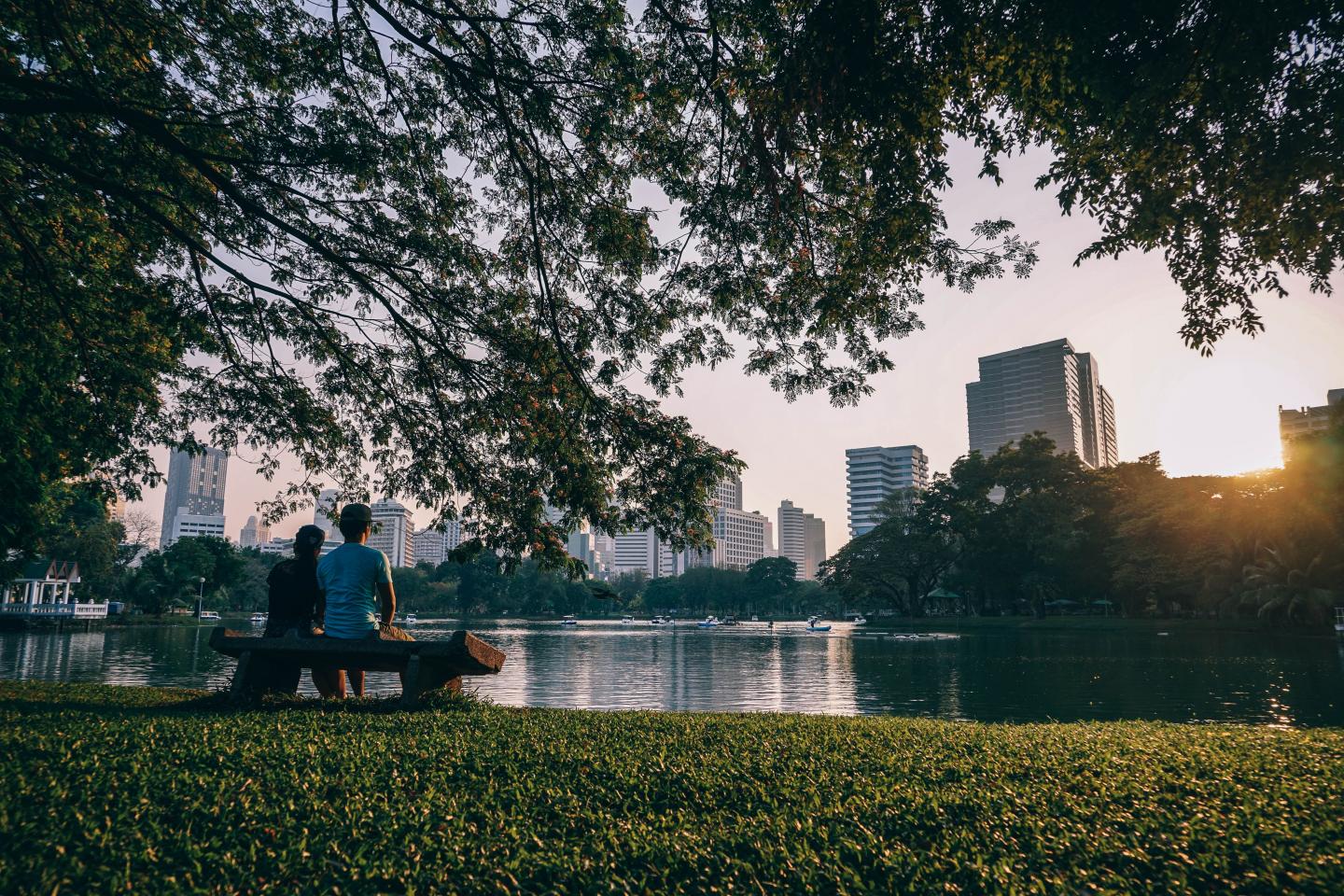 Couple Sitting on Bench Near Body of Water
