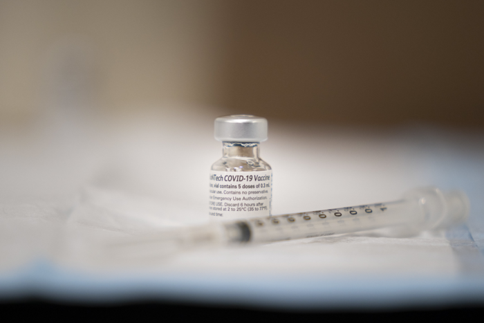 COVID-19 vaccine vial and needle