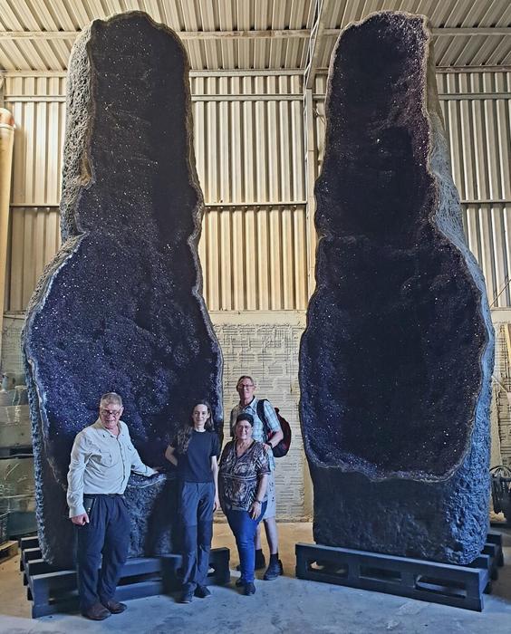 Researchers in front of giant amethyst geode in Uruguay