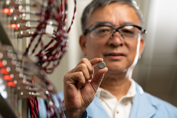 Jason Zhang holds an experimental sodium-ion battery