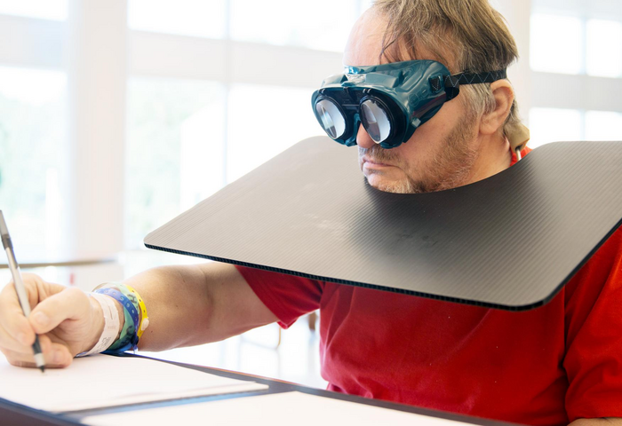 An individual with post-stroke spatial neglect wearing prism goggles for a session of prism adaptation treatment