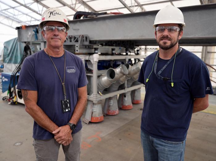 U.S. Naval Research Laboratory’s (NRL) Center for Corrosion Science and Engineering Engineer Jimmy Tagert and Tim Wise, a Senior Engineer with Precise Systems and NRL contractor install an improved Thermal Spray Nonskid (TSN) on the USS Kearsarge (LHD-3