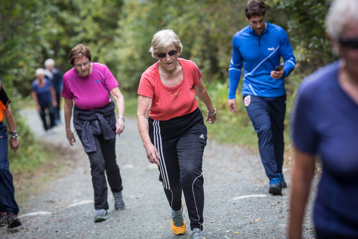elderly exercising; closeup on gravel path