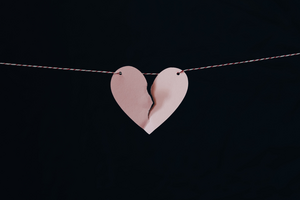 A torn paper heart on a string.