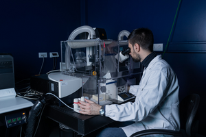 Mattia Volta examining samples at the microscope, close up