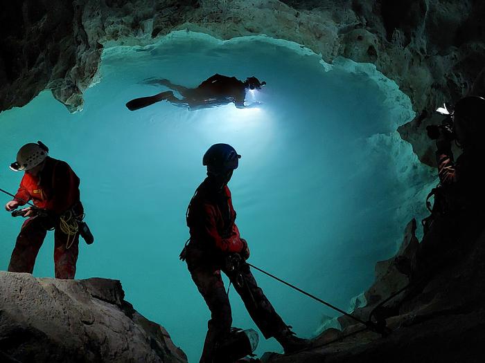 A caver in an underground lake