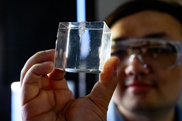 Bingyang Zhang inspects a synthetic gel designed to mimic animal tissue.