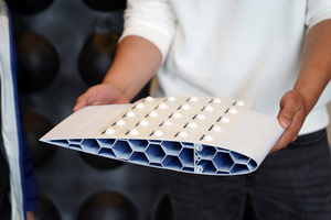 Researcher holds model of drone wing