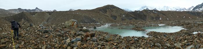 Ryan Irvine surveying rocky terrain near Lyell Glacier.