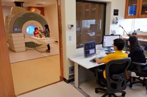 Brooks Casas and Jungmeen Kim-Spoon analyze brain scans of a research participant at the Fralin Biomedical Research Institute.