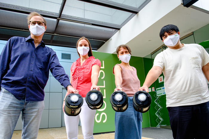 The NTU SCELSE research team holding air samplers used in their air microbiome research.