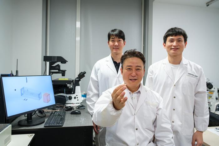 NTU Prof Cho Nam Joon, holding the new microfluidics chip, which can make precise microceramic particles in various shapes