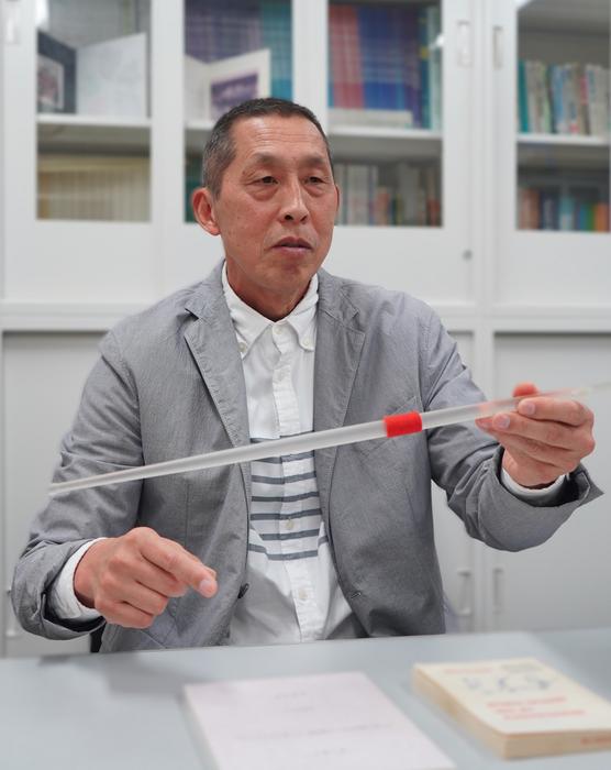 Professor MAEDA Masato holding a model of a javelin