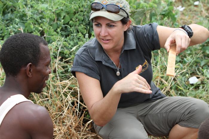 Dr Lucy King working with beehive fence farmers