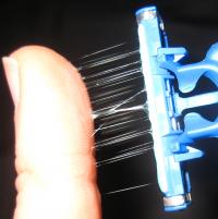 Stretching a Moistened Material Contained in a Strip on the Leading Edge of Disposable Razors
