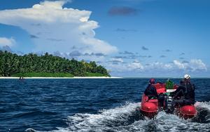 Ruth Dunn (left) and other members of the research team head out to survey the coral reefs around an island where rats are present