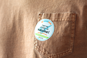 A person in California, U.S.A., wearing a “I got my COVID-19 Vaccine!” sticker.