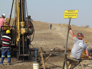 Workers use a drilling rig to collect samples of lake sediments from deep underground.