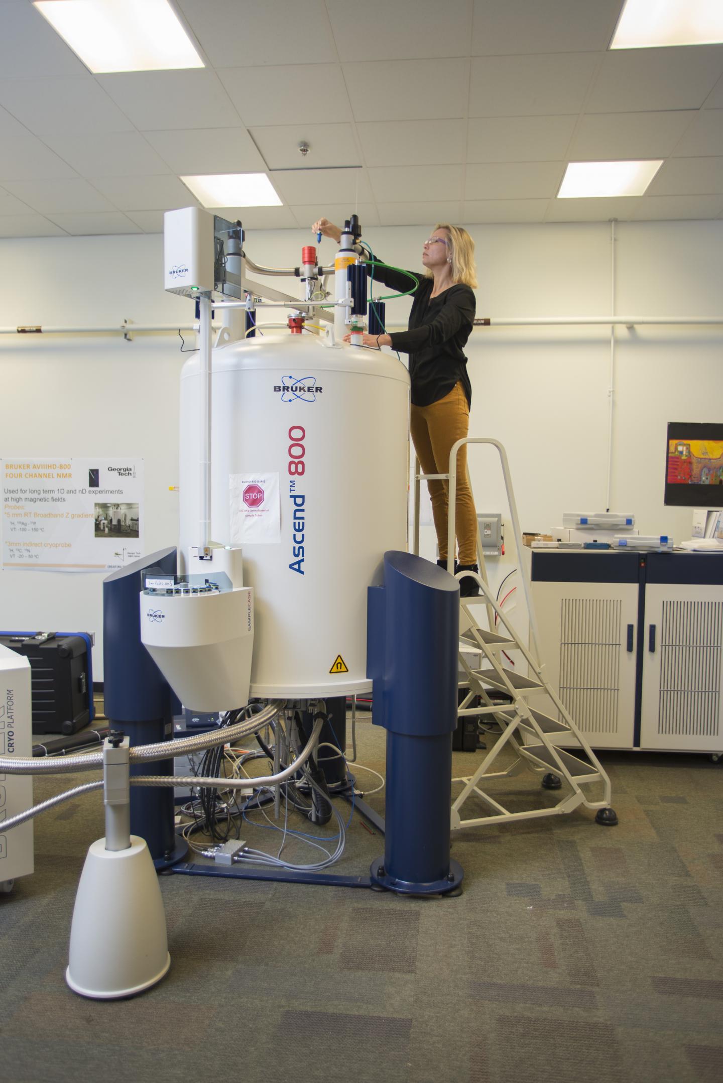 Professor Kubanek at Nuclear Magnetic Resonance Spectroscopy Device