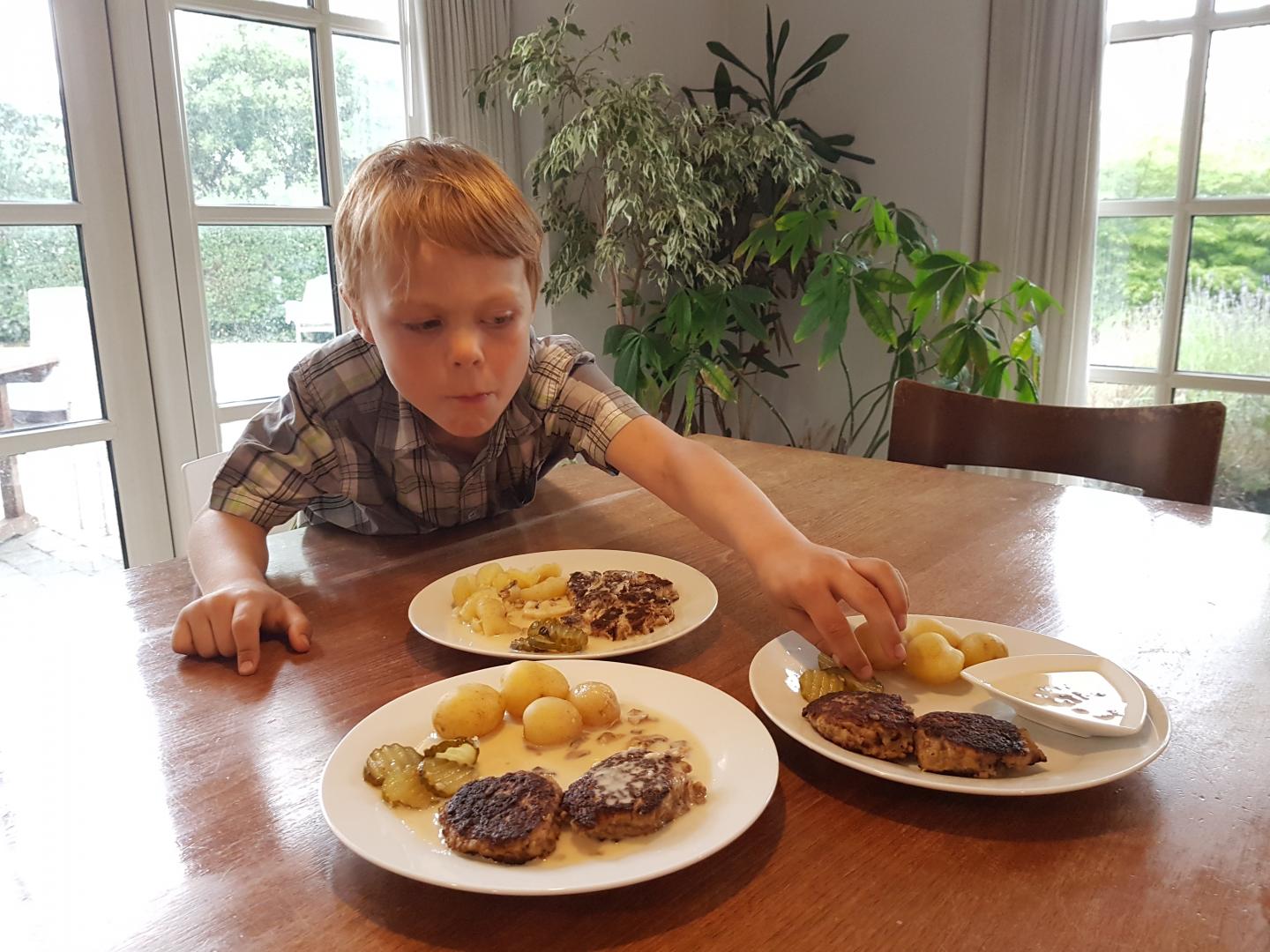 Boy Reaching for Plate