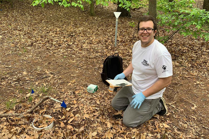 Luca Morreale doing research at a forest edge at the Arnold Arboretum.