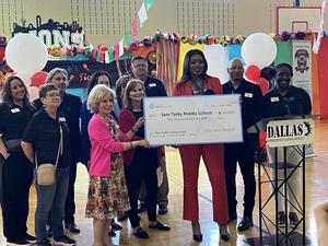 Sam Tasby Middle School receiving check at assembly