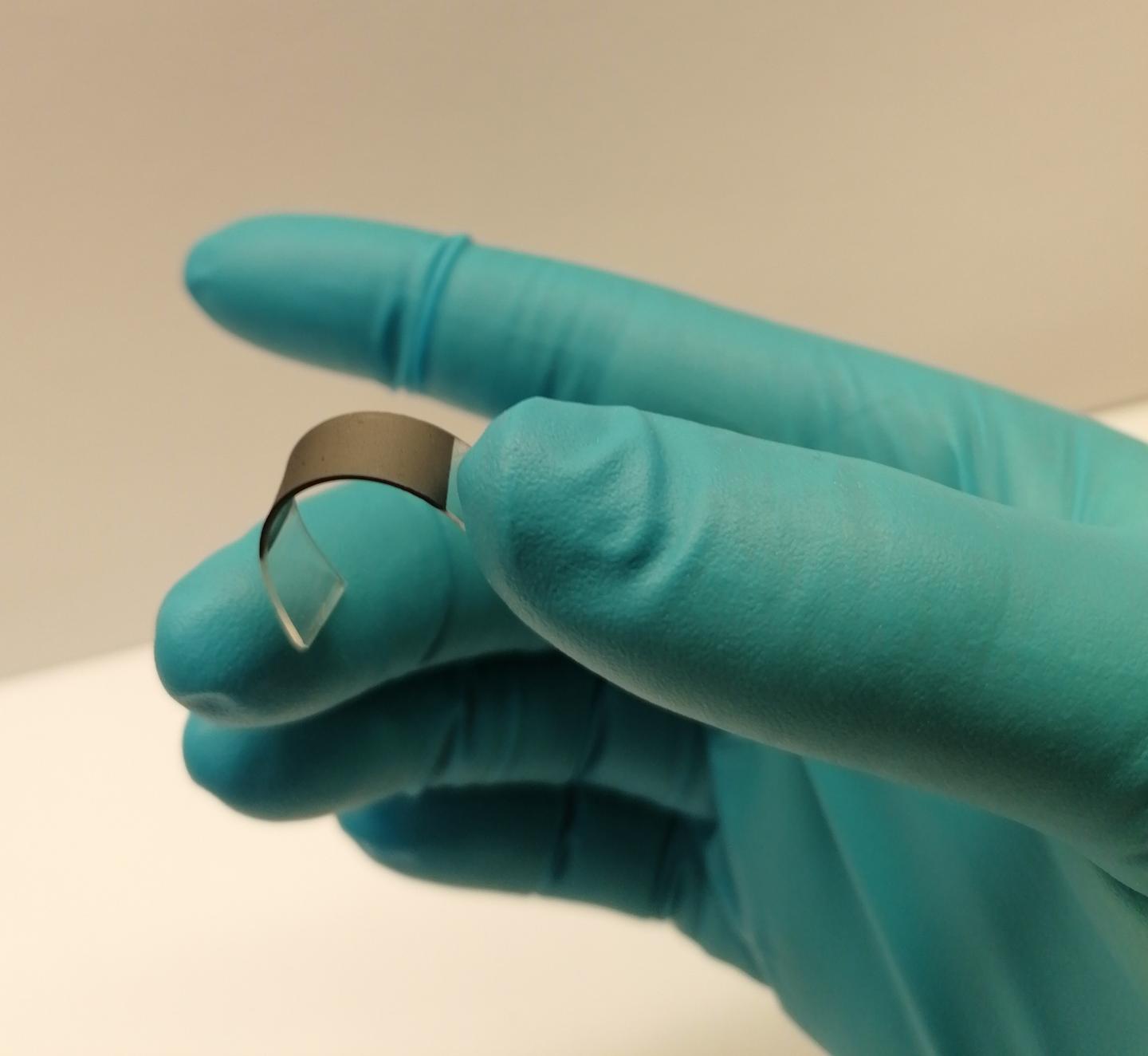 Sussex Researcher Holds a Self-Adhering Medical Patch Made from Scalably Printed Graphene Layer
