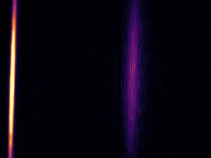 Photo of the elastically scattered X-rays (bright yellow light) and the scattered ones from the plasmons (faint violet light)