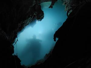 Cavers' shadows in underground lake