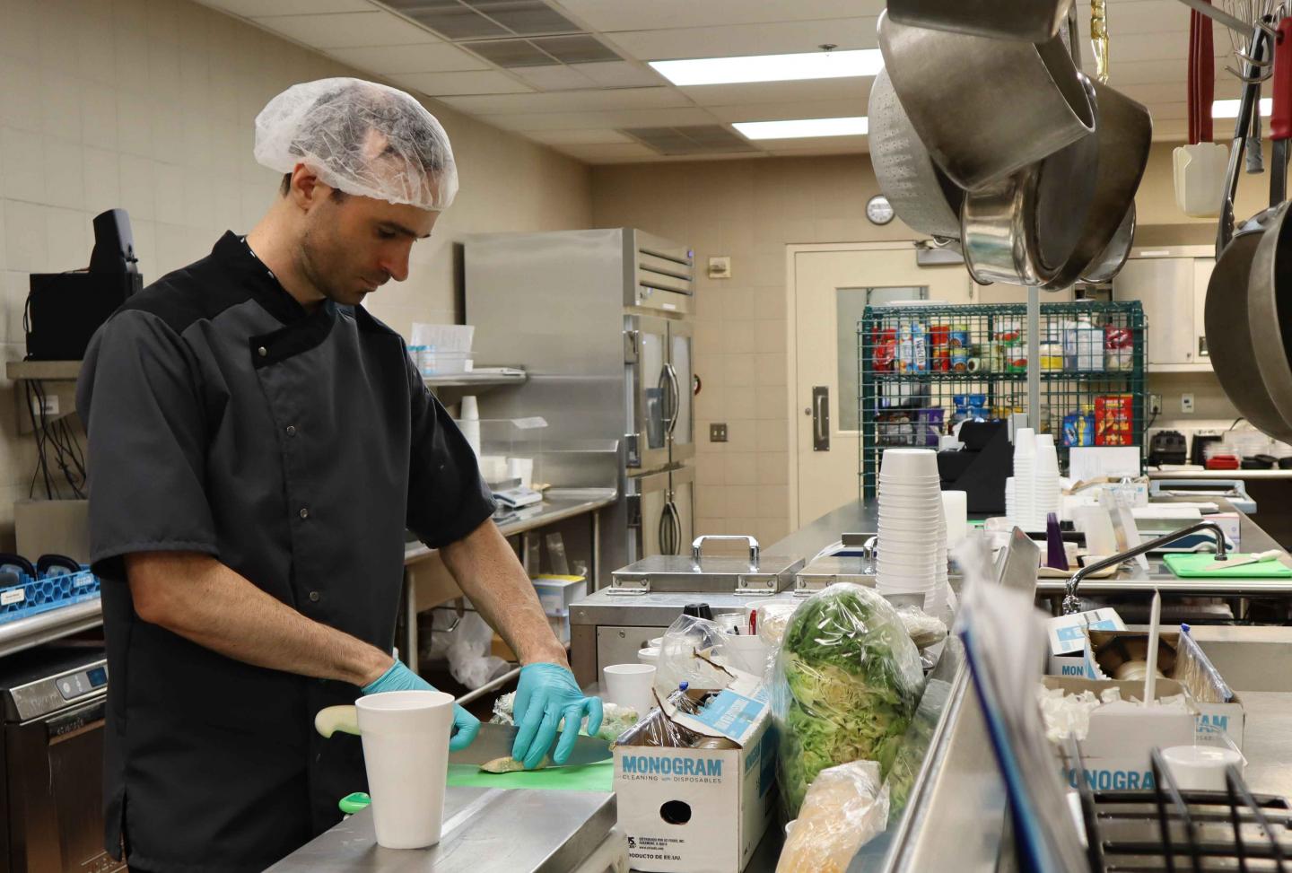 NIDDK Metabolic Kitchen 2019 -- An Employee Chops Chicken in a Hospital Kitchen