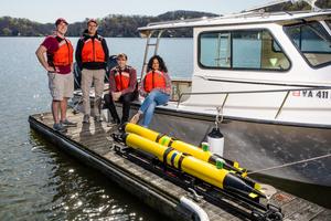 Center for Marine Autonomy and Robotics students and Co-Director Dan Stilwell (second from left) with underwater autonomous subs at Claytor Lake, near Virginia Tech's Blacksburg campus.